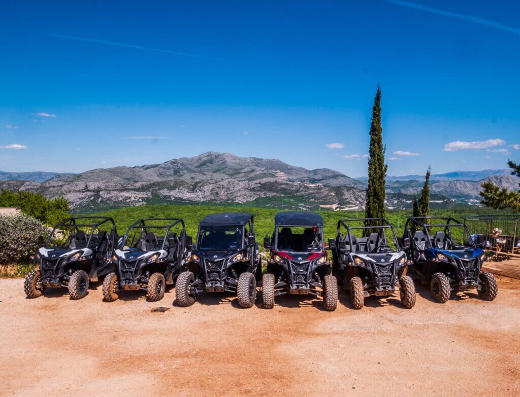 Can-Am buggies lined up at the base on Mount Srđ above Dubrovnik, ready for a team building group